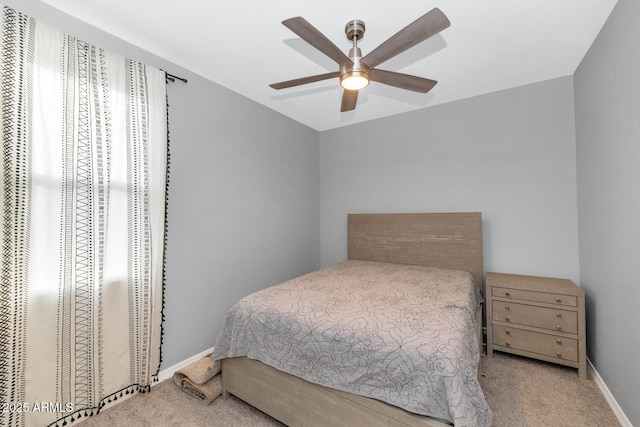 bedroom with ceiling fan and light carpet