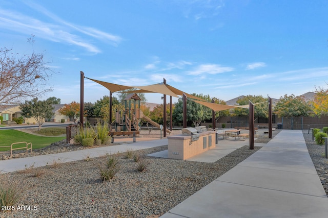 view of home's community with an outdoor kitchen and a playground