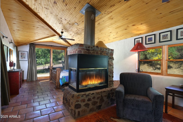 living area with wooden ceiling, a glass covered fireplace, lofted ceiling, and ceiling fan