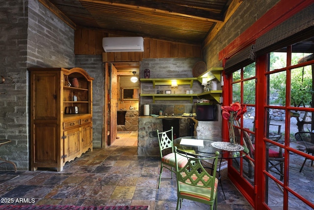 dining area featuring vaulted ceiling with beams, a wall unit AC, wooden ceiling, and stone finish flooring