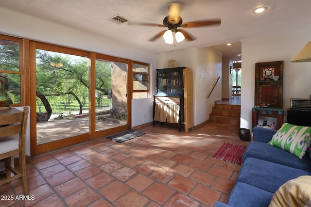 living area with a healthy amount of sunlight, visible vents, recessed lighting, and a ceiling fan
