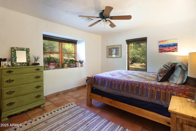 tiled bedroom with ceiling fan and visible vents