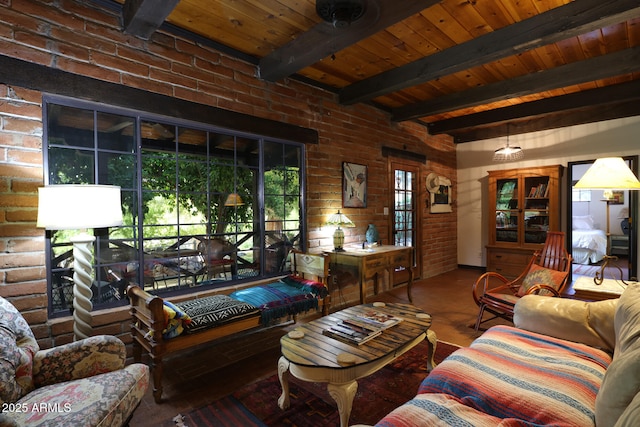 living room featuring wood ceiling, beamed ceiling, and brick wall