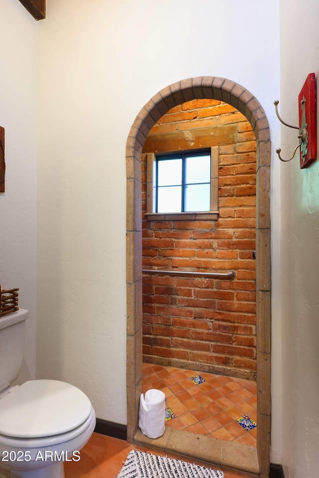 bathroom with a shower and toilet