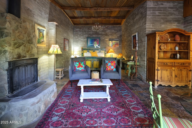 living room featuring wooden ceiling, beam ceiling, a high ceiling, a fireplace with raised hearth, and brick wall