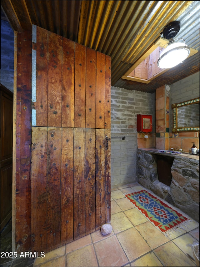 bathroom with brick wall