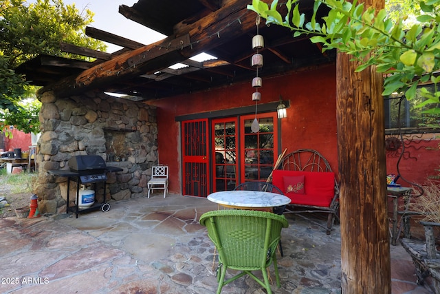 view of patio featuring french doors, a pergola, and a grill