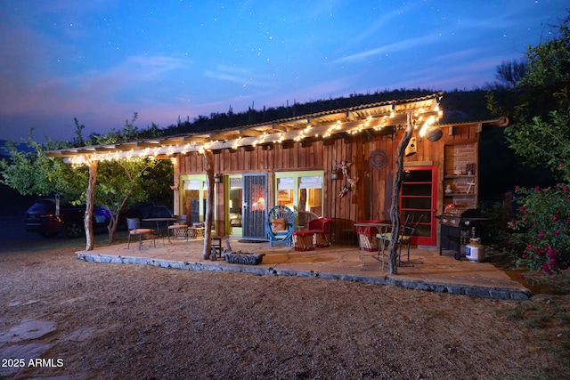 outdoor structure at dusk with a pergola