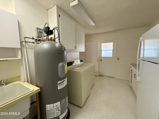 laundry room featuring washing machine and clothes dryer, sink, cabinets, water heater, and a textured ceiling