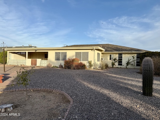 ranch-style home featuring a carport