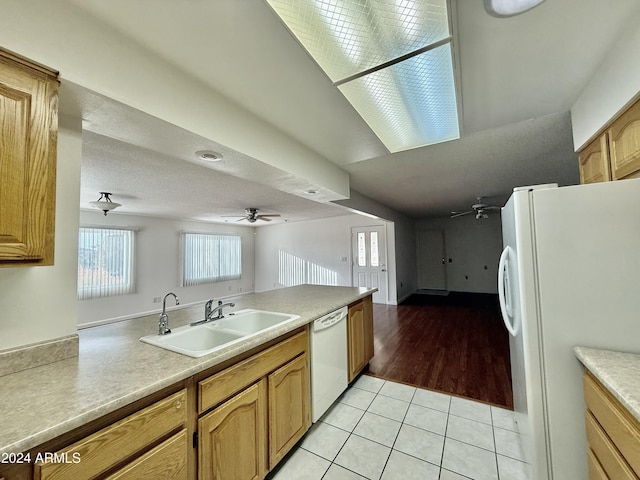 kitchen featuring white appliances, sink, ceiling fan, a textured ceiling, and light tile patterned flooring