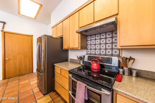 kitchen featuring ventilation hood, light brown cabinets, light stone counters, and stainless steel appliances