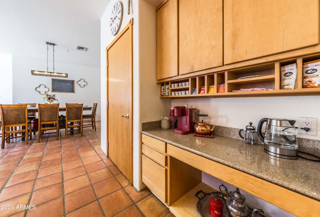 kitchen featuring pendant lighting and light tile patterned floors