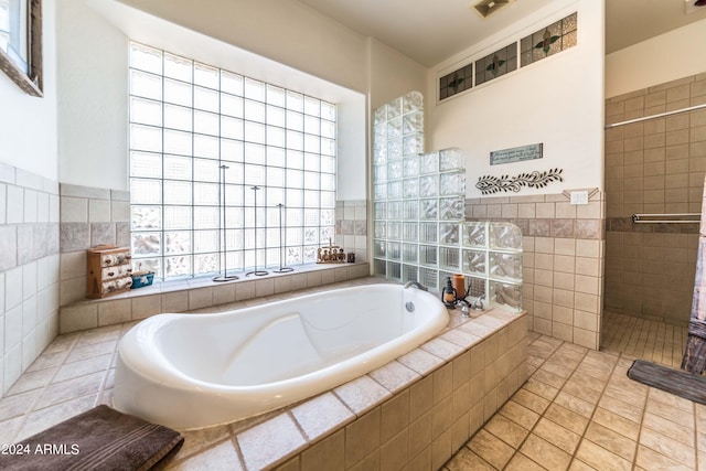 bathroom featuring tile patterned floors and plus walk in shower