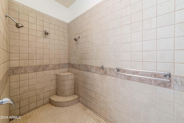 bathroom featuring tiled shower and tile patterned floors