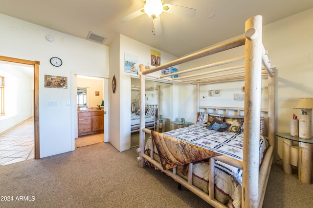 bedroom featuring ensuite bath, ceiling fan, and light colored carpet