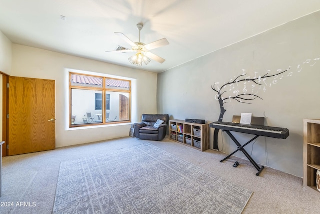 living area with ceiling fan and carpet floors