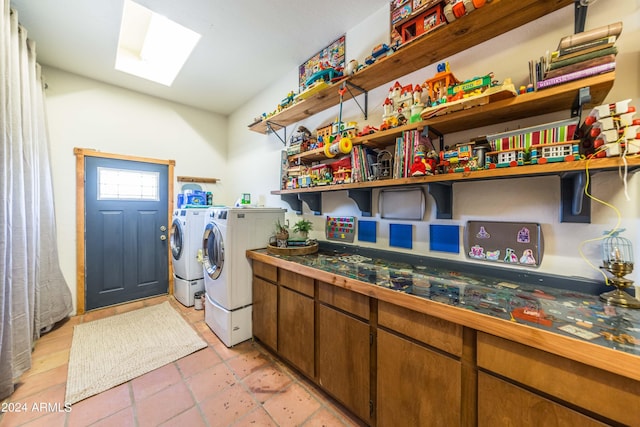 laundry room with separate washer and dryer and a skylight