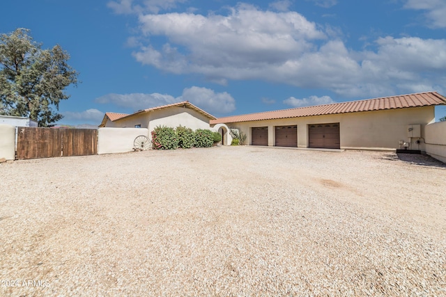 back of house featuring a garage