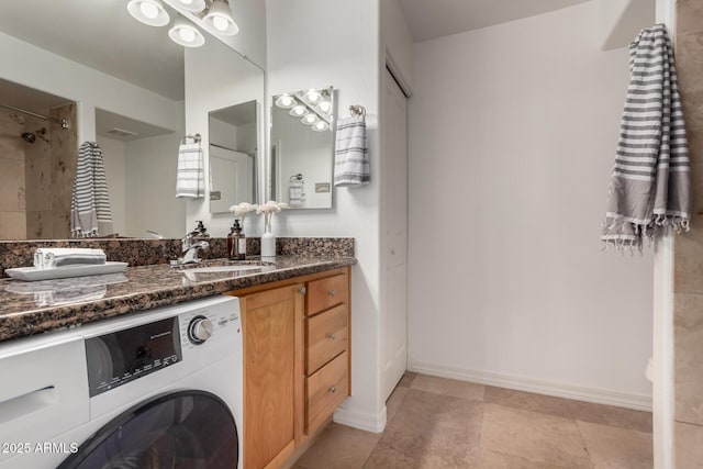 bathroom featuring vanity and washer / dryer