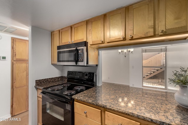 kitchen with dark stone countertops, light tile patterned floors, and electric range