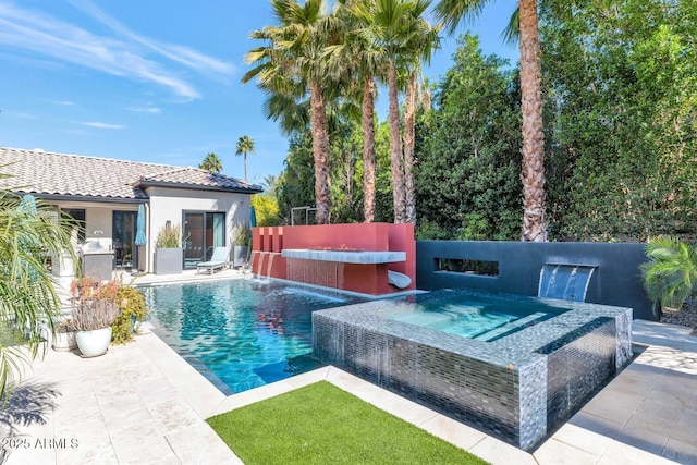 outdoor pool with fence, a patio, and an in ground hot tub