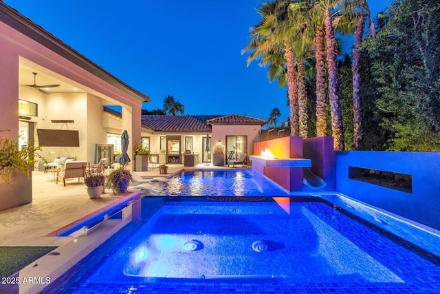 outdoor pool with an in ground hot tub and a patio