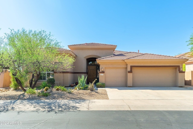 mediterranean / spanish house featuring a garage