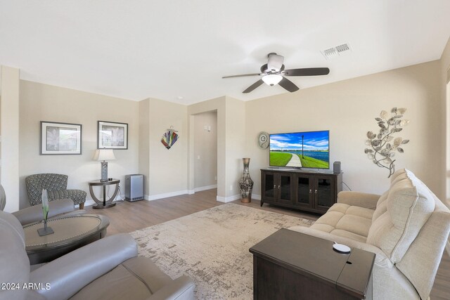 living room featuring ceiling fan and hardwood / wood-style flooring