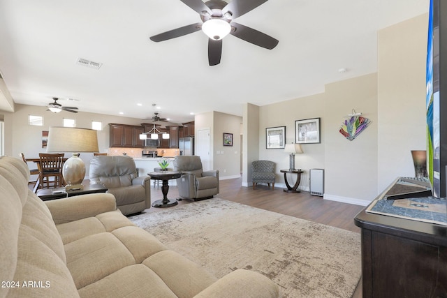 living area with recessed lighting, ceiling fan, dark wood-style flooring, baseboards, and visible vents