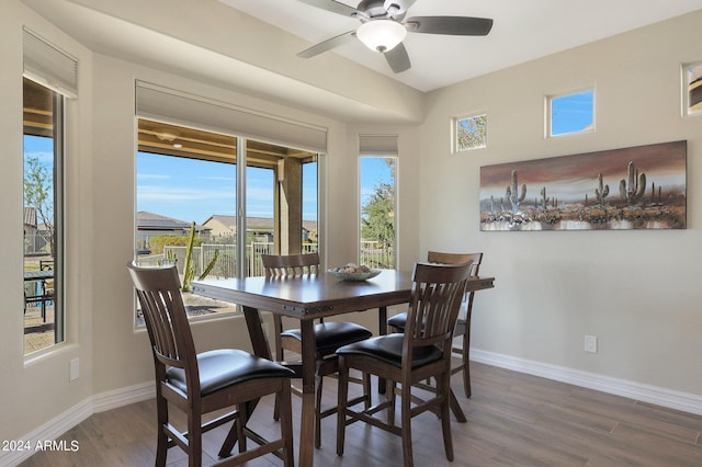dining space with wood finished floors, plenty of natural light, a ceiling fan, and baseboards