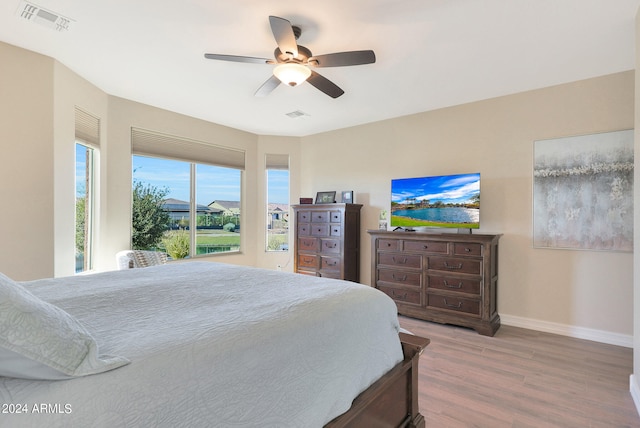 bedroom with ceiling fan and hardwood / wood-style flooring