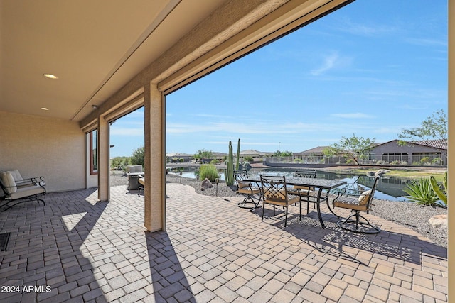 view of patio featuring outdoor dining space and a water view