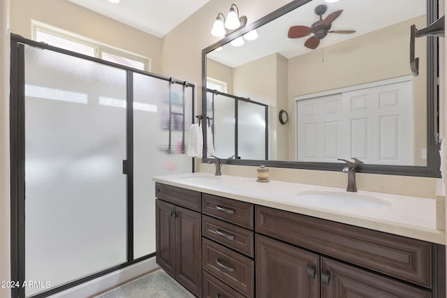 bathroom with vanity, ceiling fan, and walk in shower