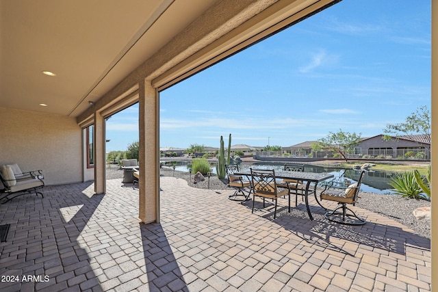 view of patio with a water view