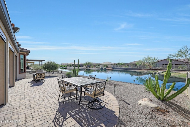 view of patio featuring a water view and outdoor dining area