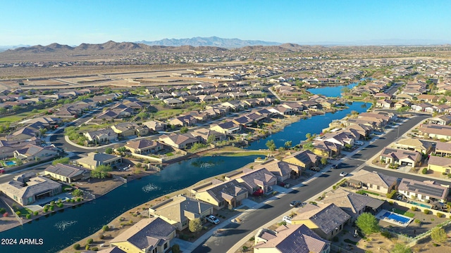 drone / aerial view with a water and mountain view and a residential view