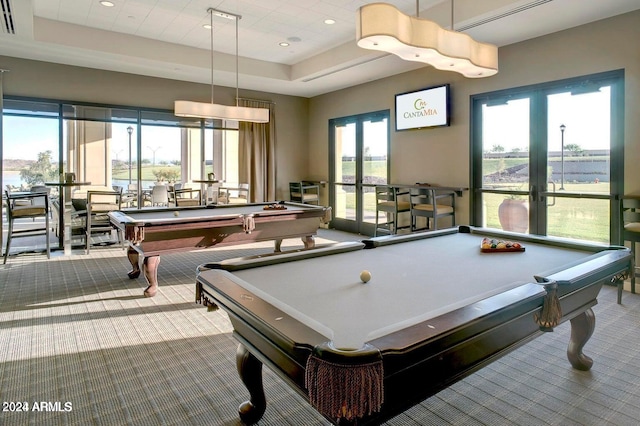 recreation room with a tray ceiling, billiards, and light colored carpet