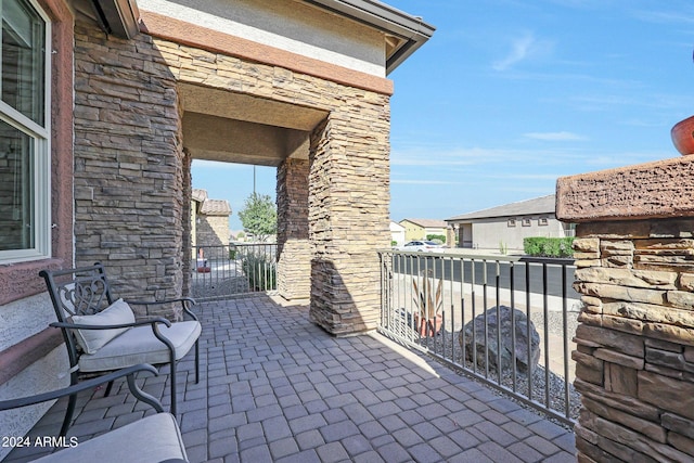 view of patio / terrace with a balcony and a residential view