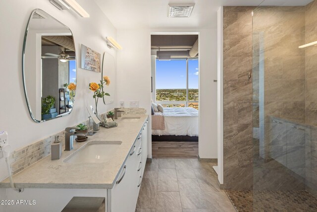 1 E Lexington Ave Unit 1209, Phoenix, AZ 85012 - ensuite bathroom featuring double vanity, tiled shower, and a ceiling fan