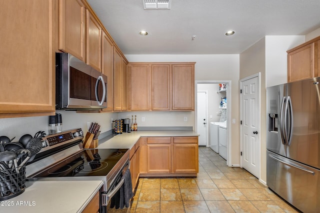 kitchen featuring visible vents, recessed lighting, washer and clothes dryer, light countertops, and appliances with stainless steel finishes