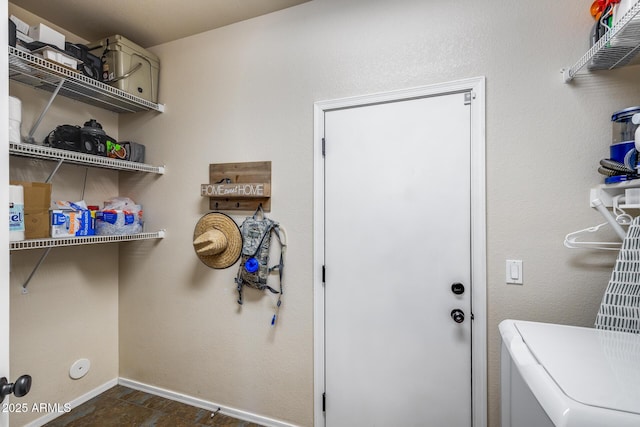 laundry room with baseboards