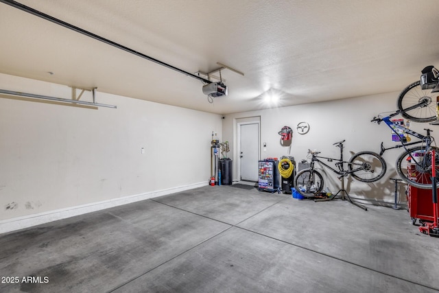garage featuring baseboards and a garage door opener