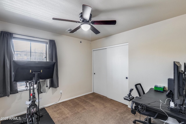 carpeted home office with visible vents, baseboards, and ceiling fan