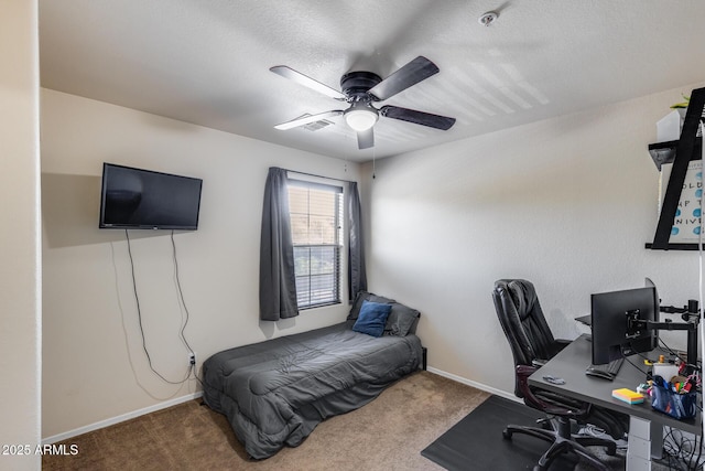 carpeted bedroom with a ceiling fan, baseboards, and a textured ceiling
