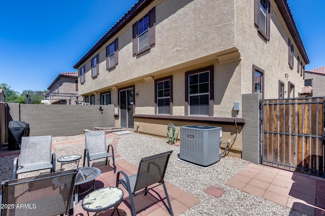 view of patio / terrace with central air condition unit, a grill, and fence private yard