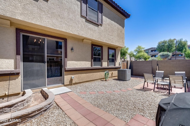 view of patio / terrace with central air condition unit and fence