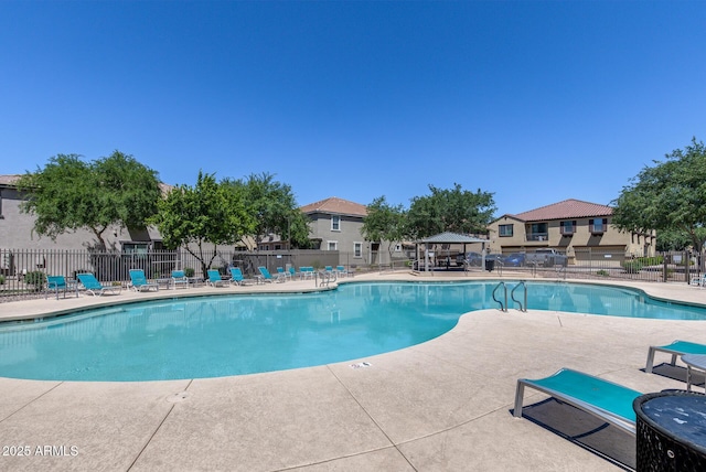 pool featuring a gazebo, fence, and a patio area