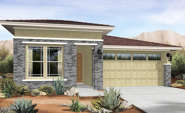 view of front of home featuring a mountain view and a garage