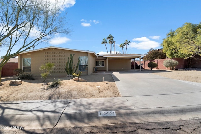 ranch-style home featuring a carport